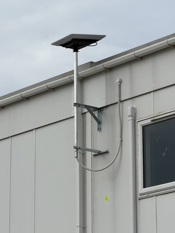 Wall mounted Starlink pole on site